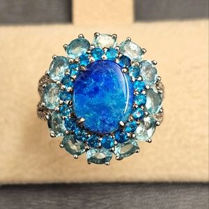 Dyed blue opal with apatite and neon apatite accents. 925 silver, size 7.